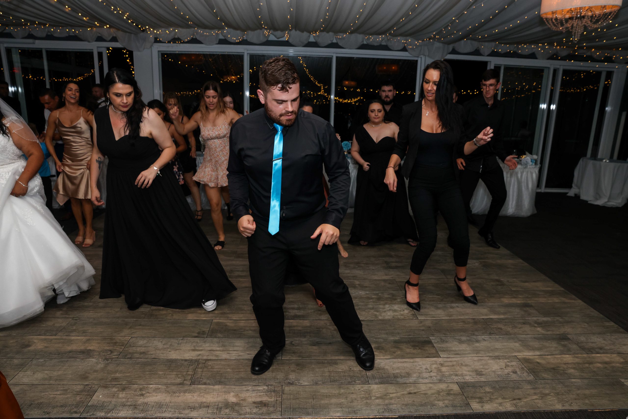 Nathan Cassar leading dances from the front of a packed dancefloor