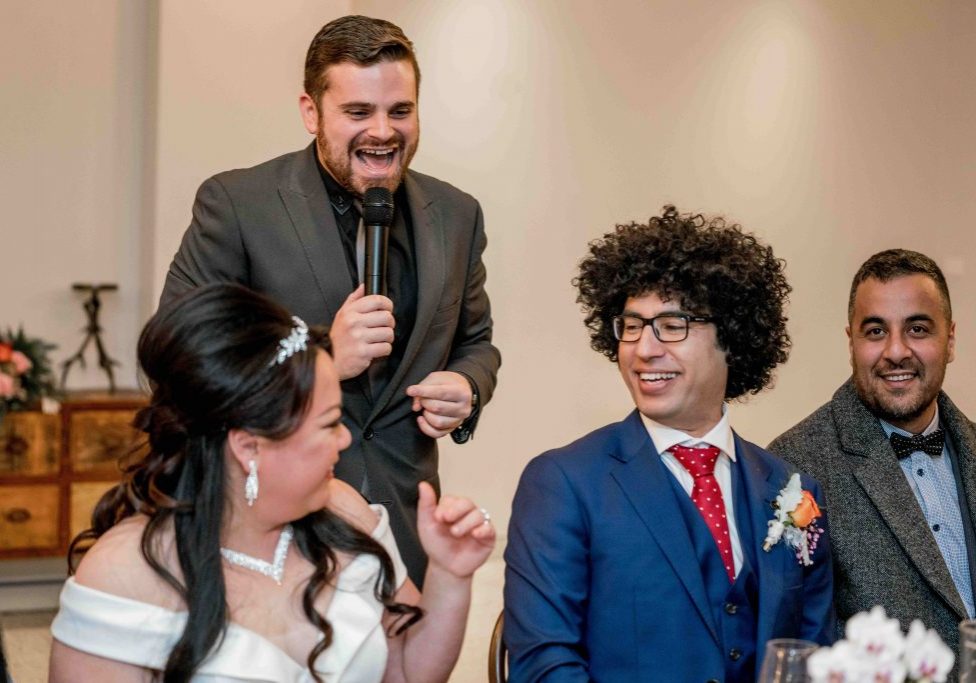 Nathan Cassar laughing with bride and groom, Cindy and Ahmad
